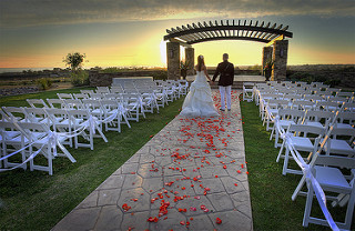 Bride and groom, beautiful sunset in the background.